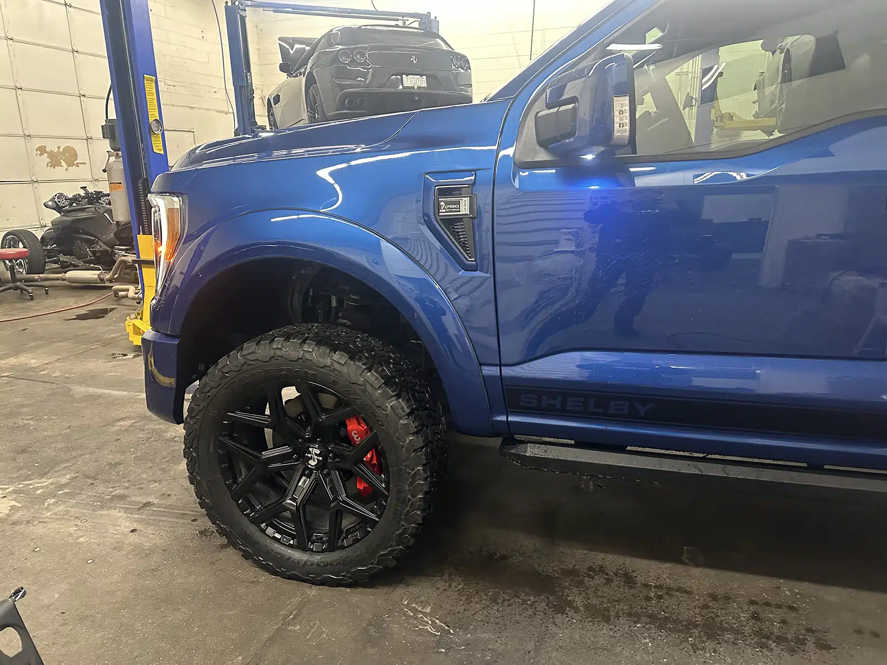 Blue truck in Evoke Autowerks shop in Englewood, CO.