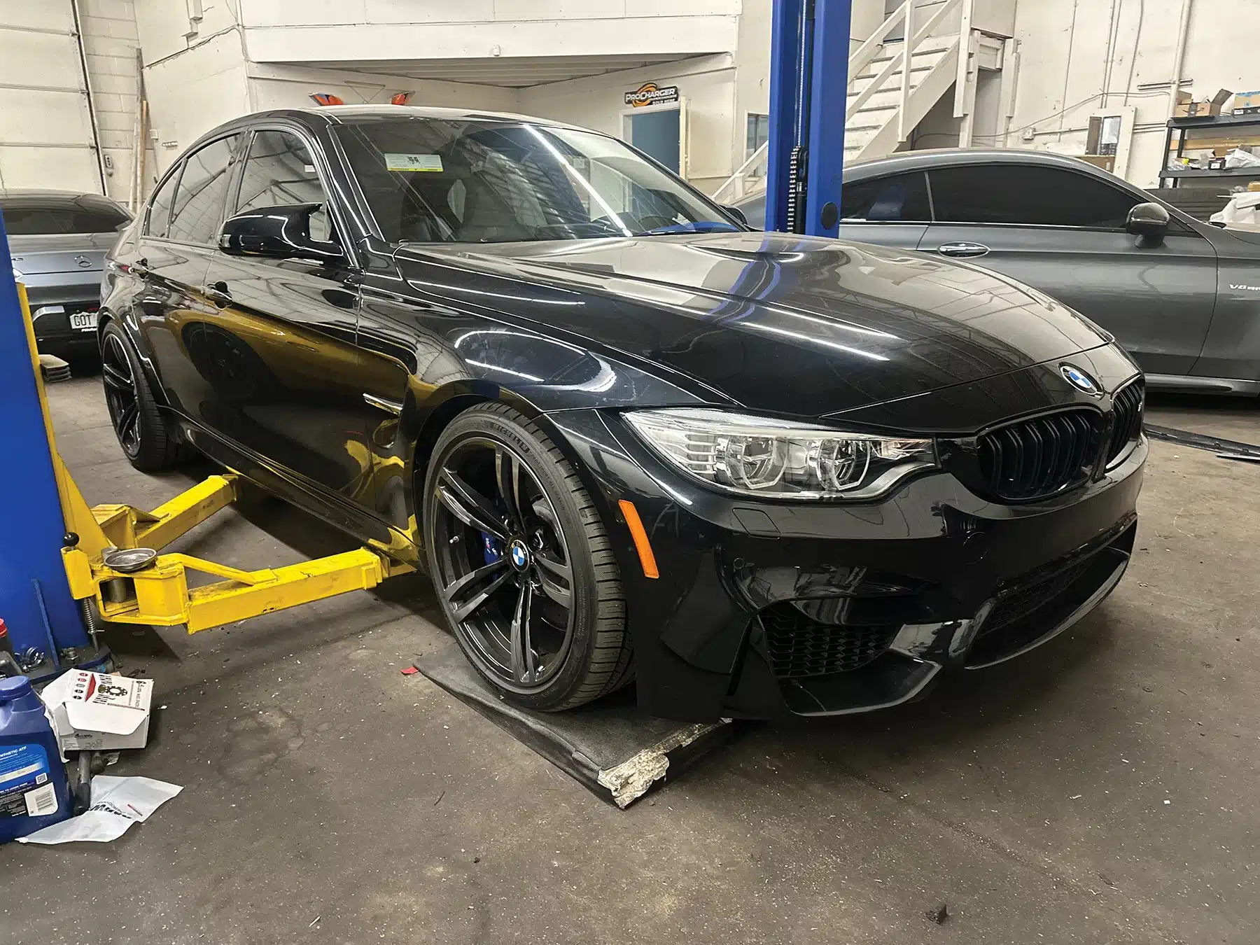 Black BMW in Evoke Autowerks shop in Englewood, CO.