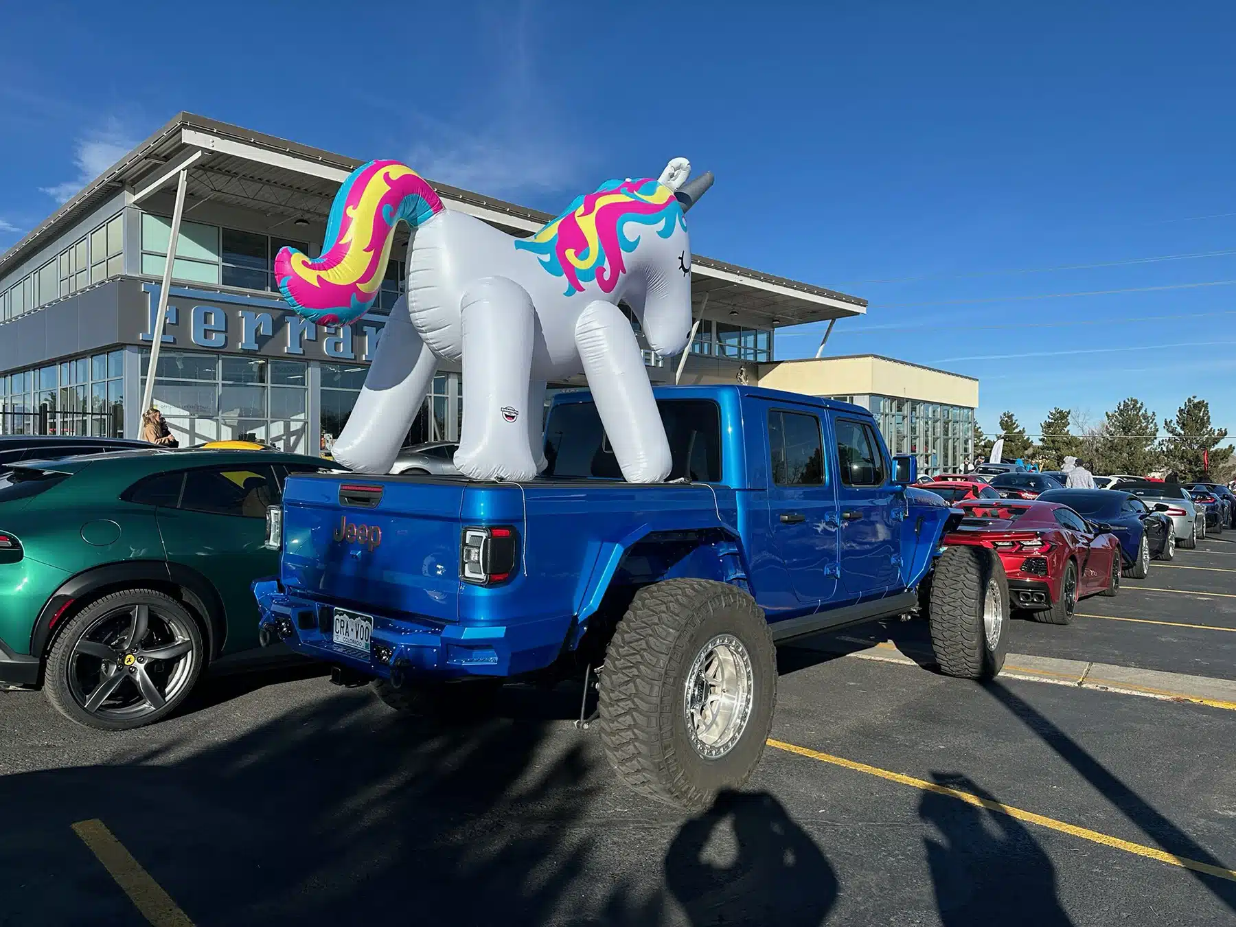 Jeep truck with blow up unicorn in the back in Englewood, CO.