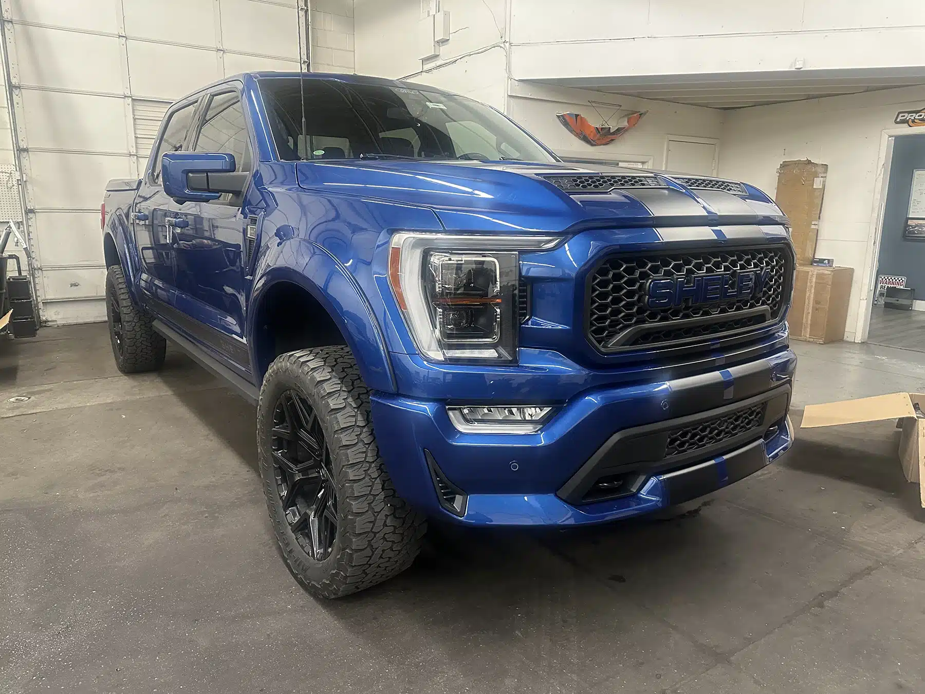 Blue truck in Evoke Autowerks shop in Englewood, CO.