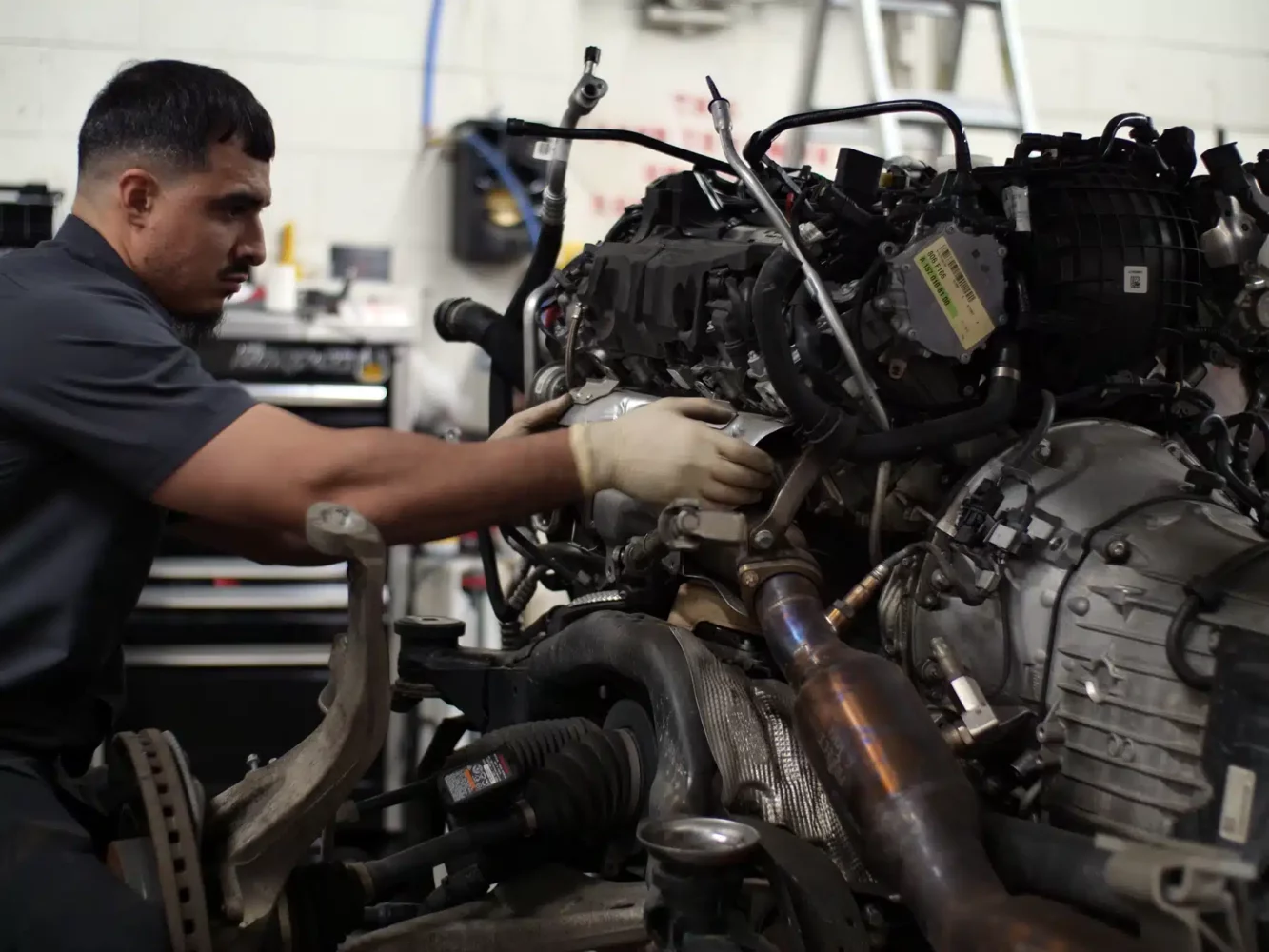 Technician working on engine in Evoke Autowerks shop in Englewood, CO.