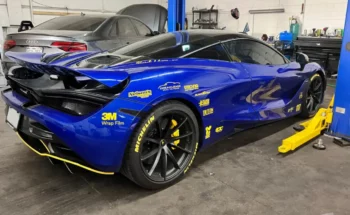 Extrerior customization on blue car in Evoke Autowerks shop in Englewood, CO.